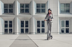 Edinco Segway Ninebot MAX G30 Gen 2 scooter in use by a person in formal attire outdoors