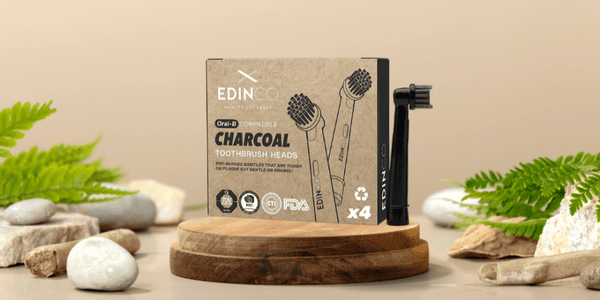 A curated selection of eco-friendly and recyclable electric toothbrush heads displayed next to a plastic-free shipping box.