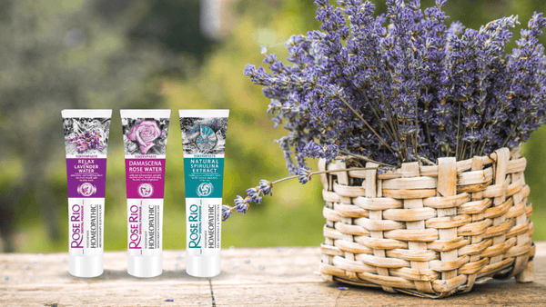 Edinco Roserio fluoride-free toothpaste tubes displayed beside a basket of lavender flowers in a natural outdoor setting