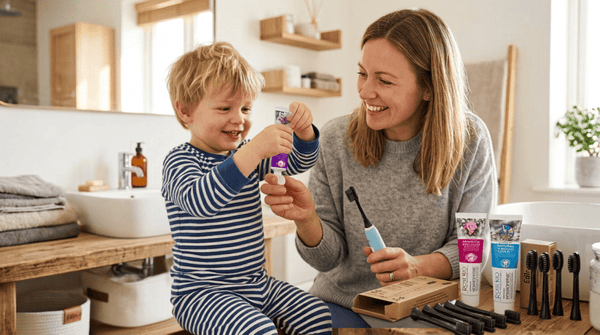 A mother and son smiling, dental routine in a bathroom, Edinco charcoal brush heads and Rose Rio homeopathic toothpaste tubes