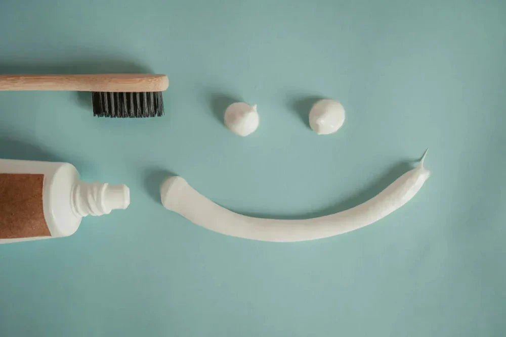 eco-friendly oral care products including charcoal toothpaste and toothbrush, and fresh mint.