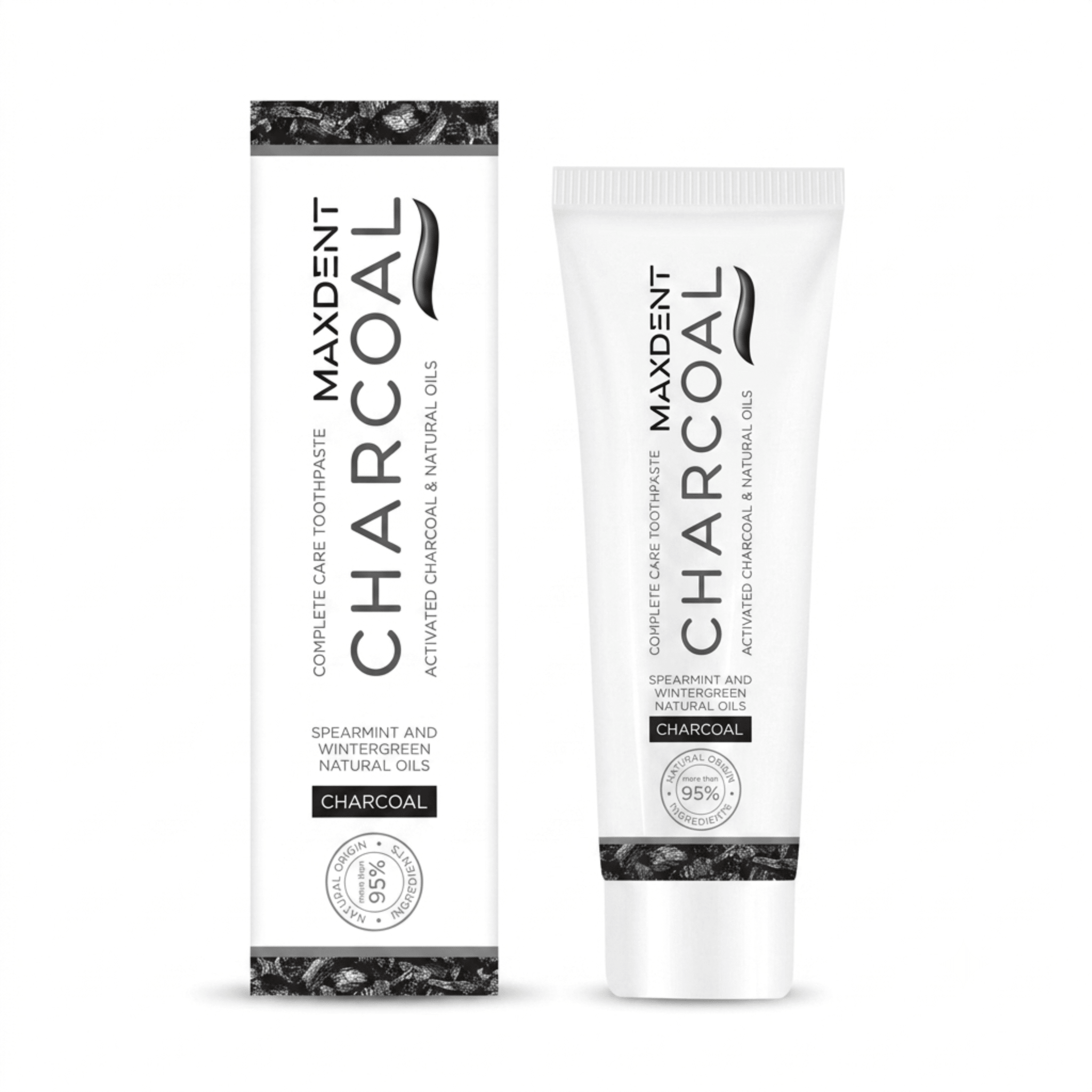 A side-by-side view of the tube and box for Maxdent Complete Care Charcoal Toothpaste. The clean white and black packaging highlights a formula of activated charcoal and natural oils, specifically spearmint and wintergreen. A prominent badge indicates that more than 95% of the ingredients are of natural origin. Supplied by sustainable UK oral care retailer, Edinco.