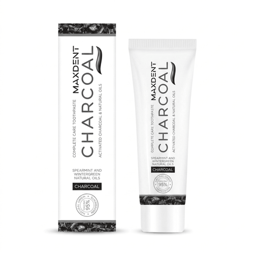 A side-by-side view of the tube and box for Maxdent Complete Care Charcoal Toothpaste. The clean white and black packaging highlights a formula of activated charcoal and natural oils, specifically spearmint and wintergreen. A prominent badge indicates that more than 95% of the ingredients are of natural origin. Supplied by sustainable UK oral care retailer, Edinco.
