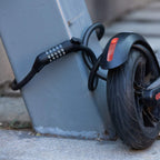 Edinco bike and scooter lock securing a scooter wheel to a post for enhanced safety