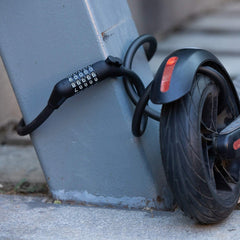 Edinco bike and scooter lock securing a scooter wheel to a post for enhanced safety
