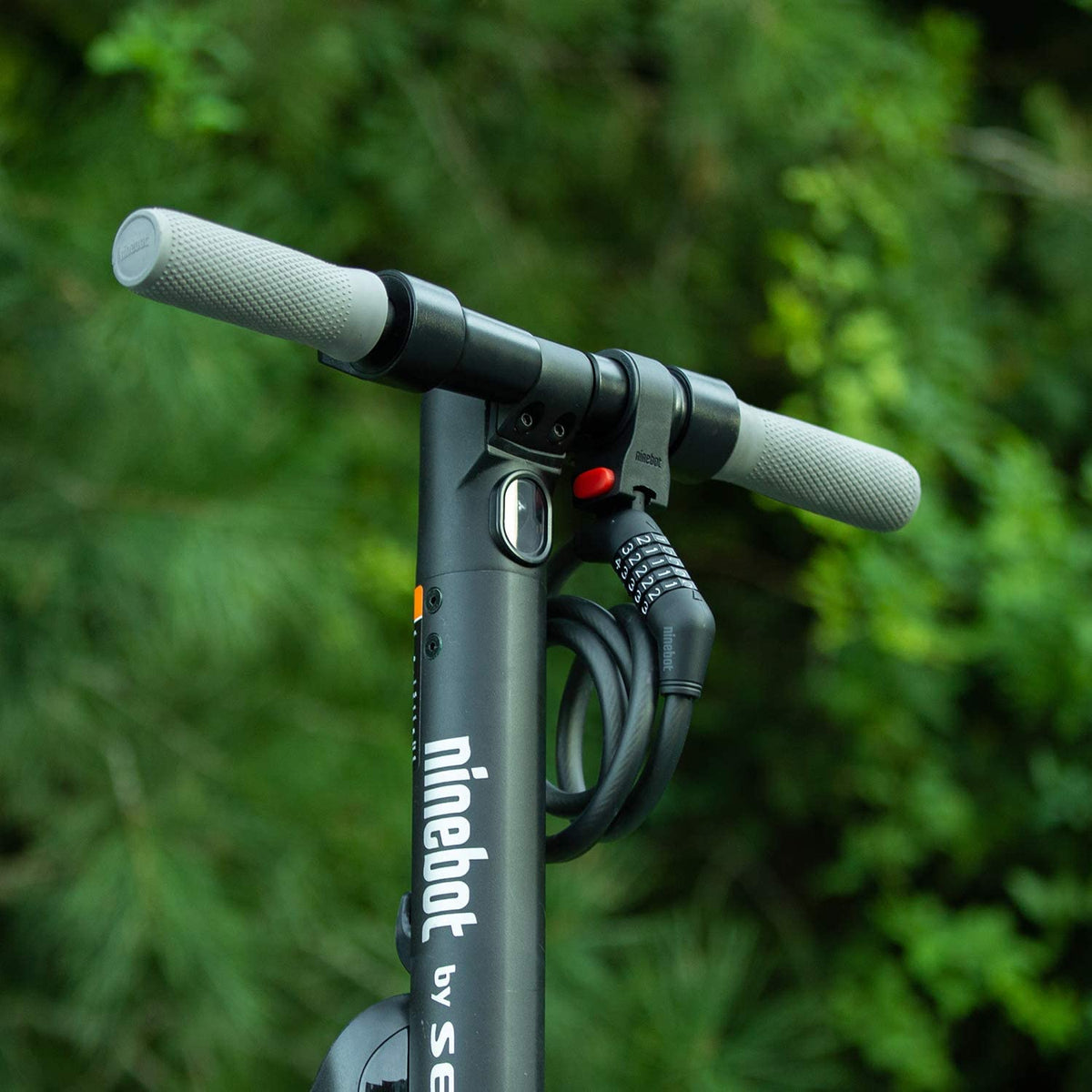 Edinco bike and scooter lock securely mounted on a Ninebot scooter handlebar outdoors