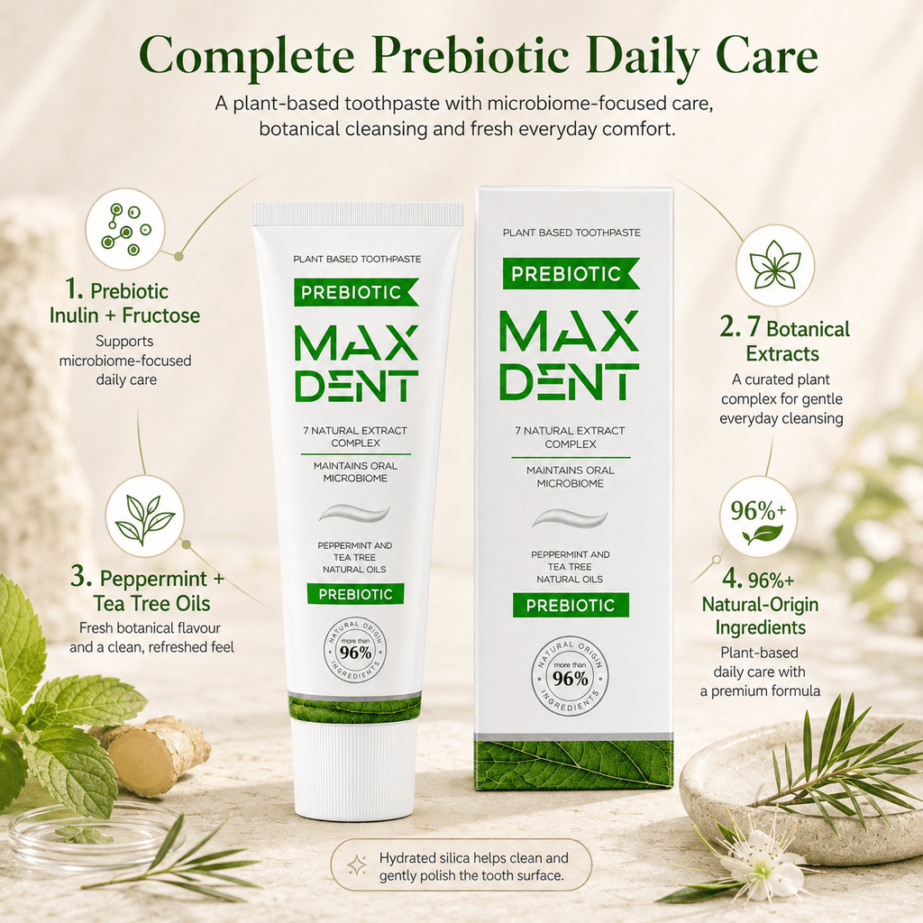 A toothpaste tube and matching box for MaxDent Prebiotic plant-based toothpaste are centered on a light beige background with botanical illustrations and text callouts about ingredients and benefits. The product packaging is white with green and teal accents, and the scene includes mint leaves, a spoonful of powder, and a small bowl of rosemary.