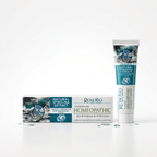 A box and tube of Rose Rio Homeopathic Toothpaste featuring Natural Spirulina Extract and Sea Minerals, displayed with water droplets on a white background. The packaging highlights advanced care, fresh no-mint aroma, and natural xylitol for healthy teeth and gums. Distributed by eco-friendly oral care brand Edinco in the UK.