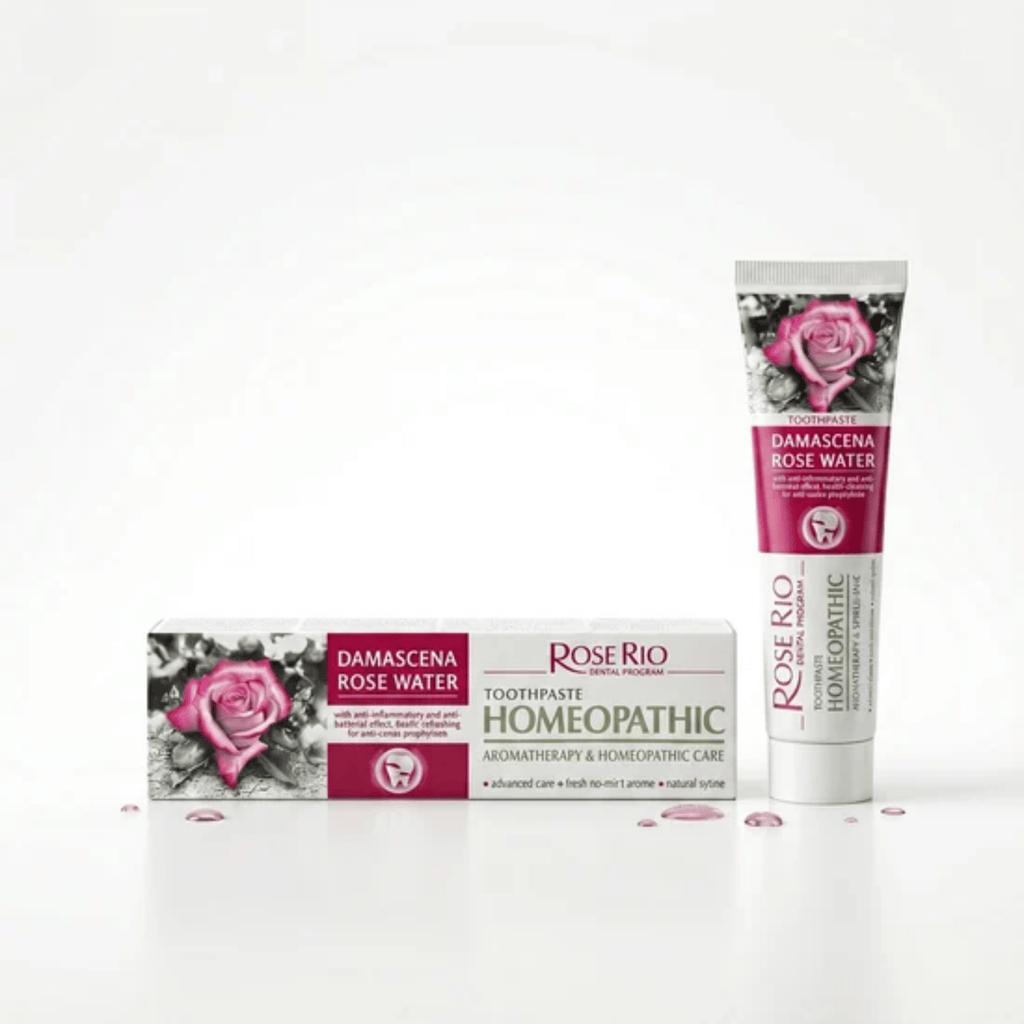 Product display of Rose Rio Dental Program Damascena Rose Water Homeopathic Toothpaste with aromatherapy care. A white and pink box sits next to a standing squeeze tube against a clean white background, distributed in the UK by Edinco