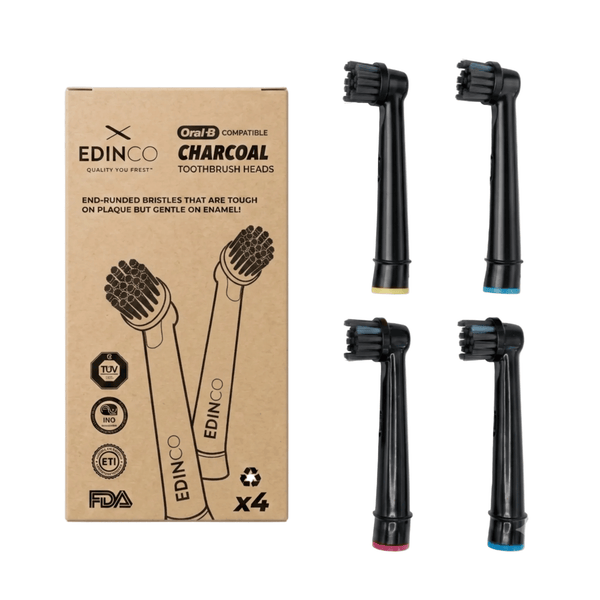 A 4-pack of Edinco Charcoal Toothbrush Heads, fully compatible with Oral-B electric toothbrushes. Displayed alongside a sustainable kraft paper box highlighting end-rounded bristles that are tough on plaque but gentle on enamel. The packaging features official quality and safety certifications including FDA, TUV, and recycling standards. The four black replacement heads feature distinct color-coded base rings. Retailed by sustainable oral care brand Edinco, UK.
